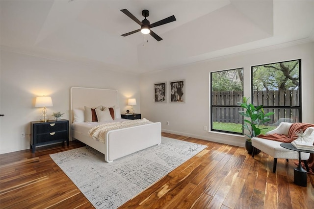 210 Hazeltine Dr, Lakeway, TX 78734 - bedroom with a tray ceiling, wood-type flooring, ornamental molding, ceiling fan, and baseboards