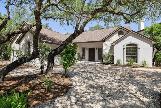 210 Hazeltine Dr, Lakeway, TX 78734 - view of front of house featuring stone siding and a chimney
