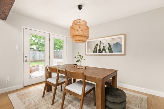 dining room featuring baseboards and light wood-style floors