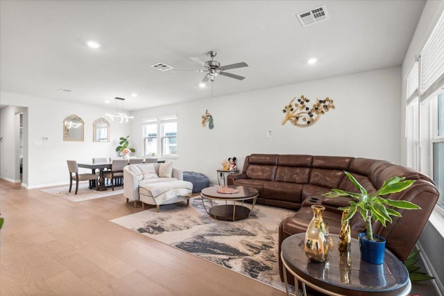 128 Green Knoll Ln, Georgetown, TX 78628 - living room featuring wood finished floors, ceiling fan, recessed lighting, and a chandelier