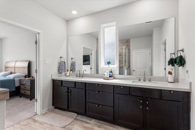 128 Green Knoll Ln, Georgetown, TX 78628 - ensuite bathroom featuring double vanity and a shower stall