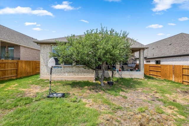 128 Green Knoll Ln, Georgetown, TX 78628 - back of property featuring brick siding and a fenced backyard