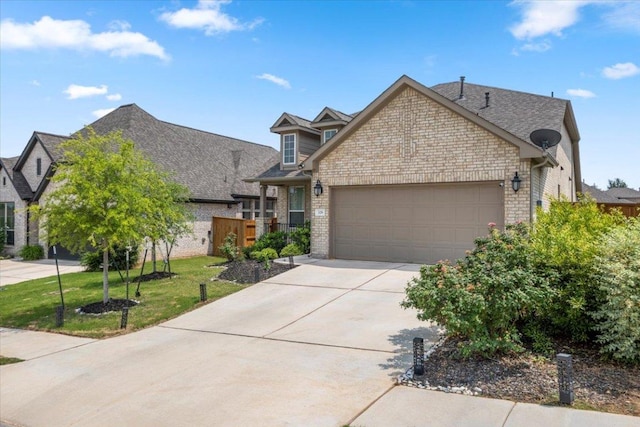 128 Green Knoll Ln, Georgetown, TX 78628 - view of front of home with a garage, driveway, brick siding, and a front lawn