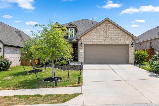 128 Green Knoll Ln, Georgetown, TX 78628 - view of front facade with an attached garage, brick siding, concrete driveway, a front lawn, and roof with shingles