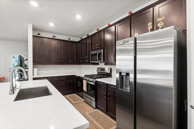 128 Green Knoll Ln, Georgetown, TX 78628 - kitchen with appliances with stainless steel finishes, dark brown cabinetry, light countertops, and recessed lighting