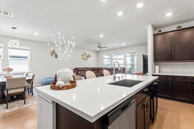 128 Green Knoll Ln, Georgetown, TX 78628 - kitchen with dishwasher, light wood-style flooring, ceiling fan, recessed lighting, and a kitchen island with sink