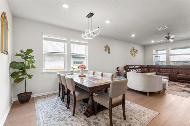 128 Green Knoll Ln, Georgetown, TX 78628 - dining area with light wood-style floors, recessed lighting, a ceiling fan, and a chandelier