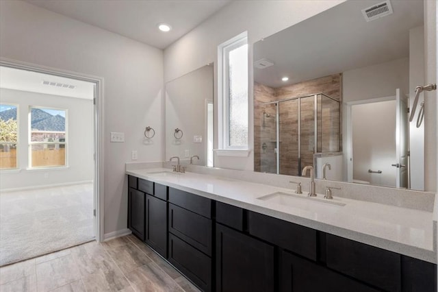 128 Green Knoll Ln, Georgetown, TX 78628 - bathroom featuring double vanity and a shower stall
