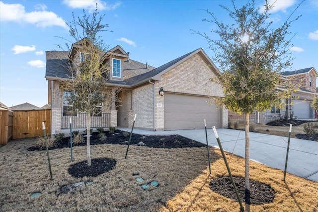 128 Green Knoll Ln, Georgetown, TX 78628 - view of front of house with brick siding, a garage, a porch, driveway, and a shingled roof