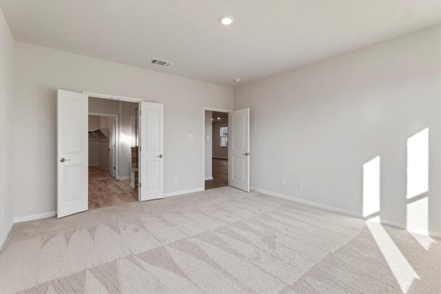 128 Green Knoll Ln, Georgetown, TX 78628 - unfurnished bedroom with light colored carpet, a spacious closet, and recessed lighting