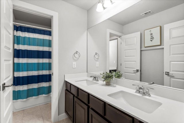 7207 Auburn Blaze Ln, Austin, TX 78744 - bathroom featuring double vanity, tile patterned floors, and curtained shower
