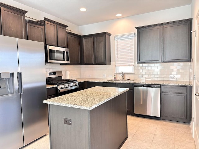 137 Rustic Glen Dr, San Marcos, TX 78666 - kitchen featuring stainless steel appliances, a sink, dark brown cabinets, tasteful backsplash, and light stone countertops