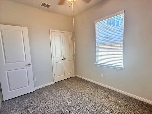 137 Rustic Glen Dr, San Marcos, TX 78666 - unfurnished bedroom with carpet floors, multiple windows, baseboards, and a closet