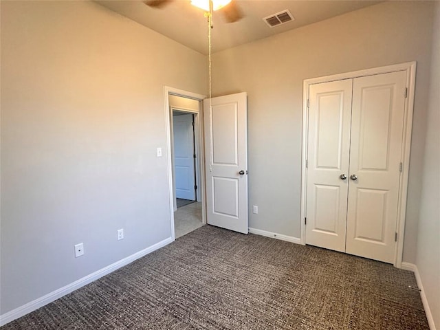 137 Rustic Glen Dr, San Marcos, TX 78666 - unfurnished bedroom with dark colored carpet, baseboards, a closet, and a ceiling fan
