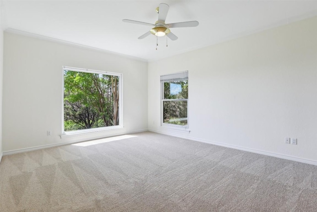 empty room with carpet floors, baseboards, and a ceiling fan