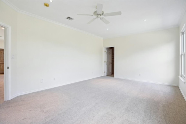 empty room featuring ceiling fan, light carpet, crown molding, baseboards, and recessed lighting