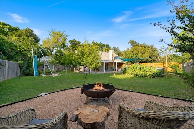 view of yard with an outdoor fire pit and a patio