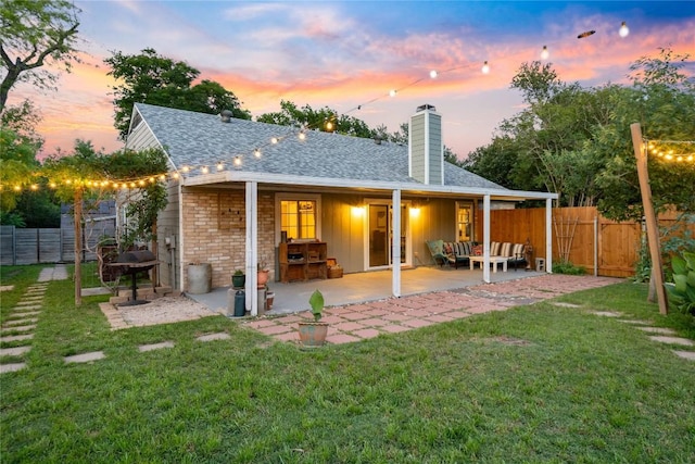 8304 Avocet Dr, Austin, TX 78745 - back of house with a chimney, a patio area, roof with shingles, board and batten siding, and an outdoor hangout area