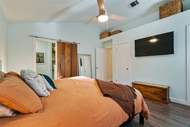 8304 Avocet Dr, Austin, TX 78745 - bedroom with wood finished floors, vaulted ceiling, a barn door, ceiling fan, and baseboards