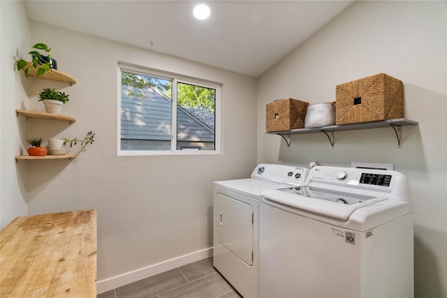 washroom featuring independent washer and dryer, baseboards, and light tile patterned flooring