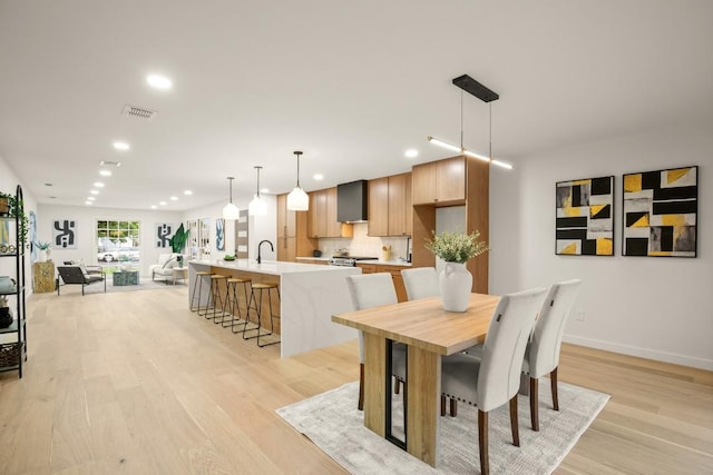 1811 Rogge Ln, Austin, TX 78723 - dining space featuring recessed lighting, light wood-style flooring, and baseboards