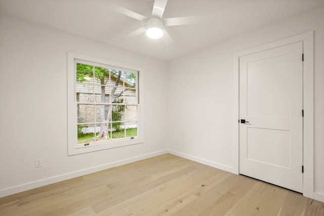 1811 Rogge Ln, Austin, TX 78723 - unfurnished room featuring light wood-style floors, baseboards, and a ceiling fan