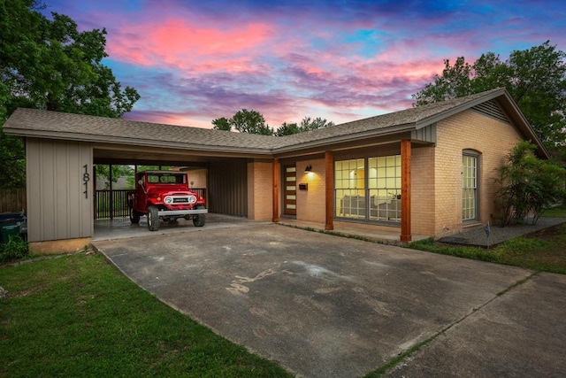 1811 Rogge Ln, Austin, TX 78723 - view of front of property featuring concrete driveway, brick siding, a carport, and roof with shingles