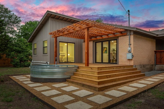 1811 Rogge Ln, Austin, TX 78723 - rear view of property with a pergola and board and batten siding