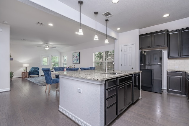 212 Beretta Cir, Georgetown, TX 78628 - kitchen with black appliances, a sink, open floor plan, healthy amount of natural light, and recessed lighting