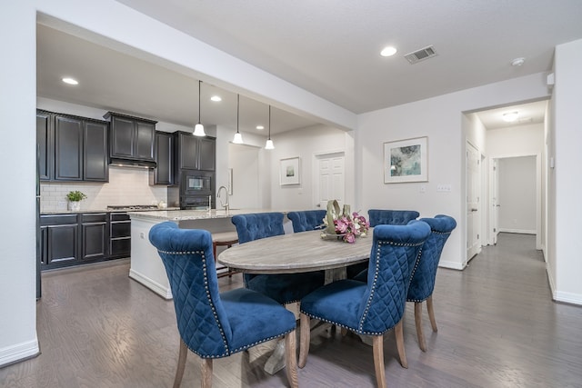 212 Beretta Cir, Georgetown, TX 78628 - dining room featuring dark wood-type flooring, baseboards, and recessed lighting