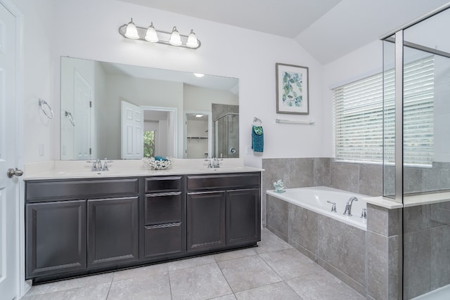 212 Beretta Cir, Georgetown, TX 78628 - full bath featuring a stall shower, a garden tub, lofted ceiling, double vanity, and tile patterned flooring