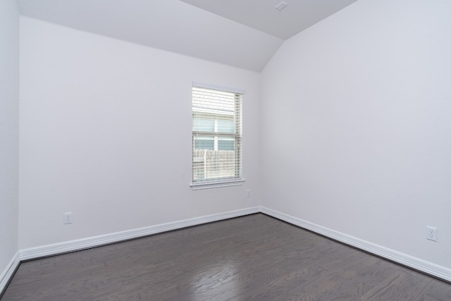 212 Beretta Cir, Georgetown, TX 78628 - empty room with vaulted ceiling, dark wood finished floors, and baseboards