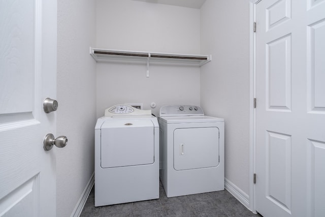 212 Beretta Cir, Georgetown, TX 78628 - laundry room featuring washing machine and dryer, baseboards, and dark tile patterned flooring