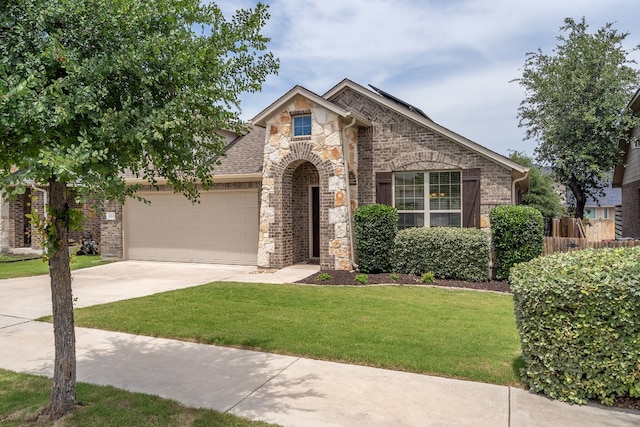 212 Beretta Cir, Georgetown, TX 78628 - view of front of property featuring an attached garage, driveway, stone siding, brick siding, and roof with shingles