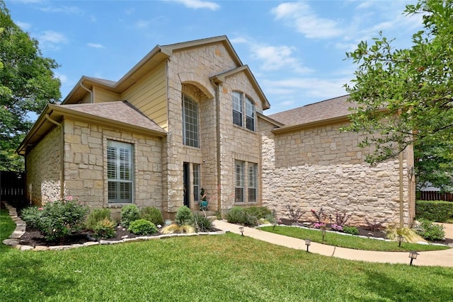 view of front of home featuring stone siding and a shingled roof