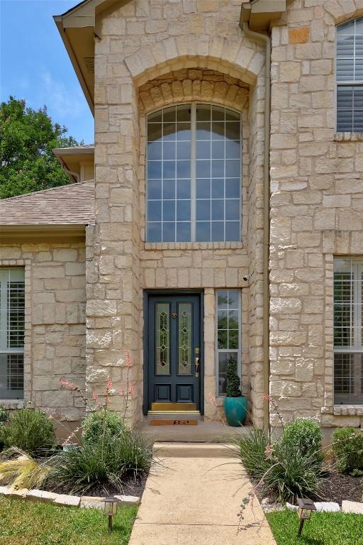 doorway to property with stone siding