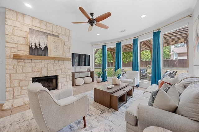 living room with ceiling fan, a fireplace, recessed lighting, and crown molding