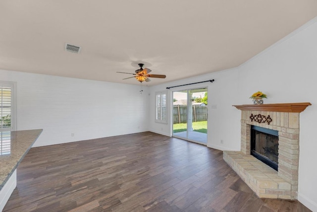 127 Edison Dr, Hutto, TX 78634 - unfurnished living room featuring a fireplace, a ceiling fan, dark wood-style floors, and baseboards