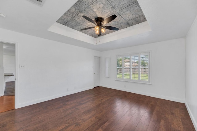 127 Edison Dr, Hutto, TX 78634 - spare room featuring a raised ceiling, hardwood / wood-style flooring, baseboards, and a ceiling fan