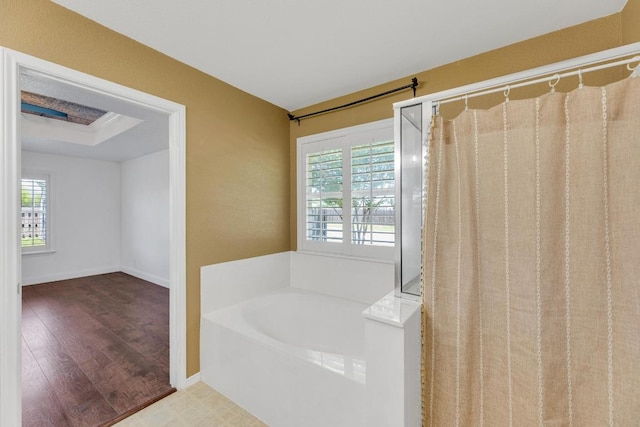 127 Edison Dr, Hutto, TX 78634 - full bathroom with a garden tub, plenty of natural light, wood finished floors, and baseboards