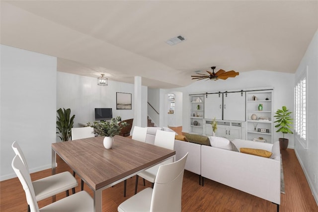 127 Edison Dr, Hutto, TX 78634 - dining space featuring stairway, wood finished floors, a ceiling fan, baseboards, and built in features