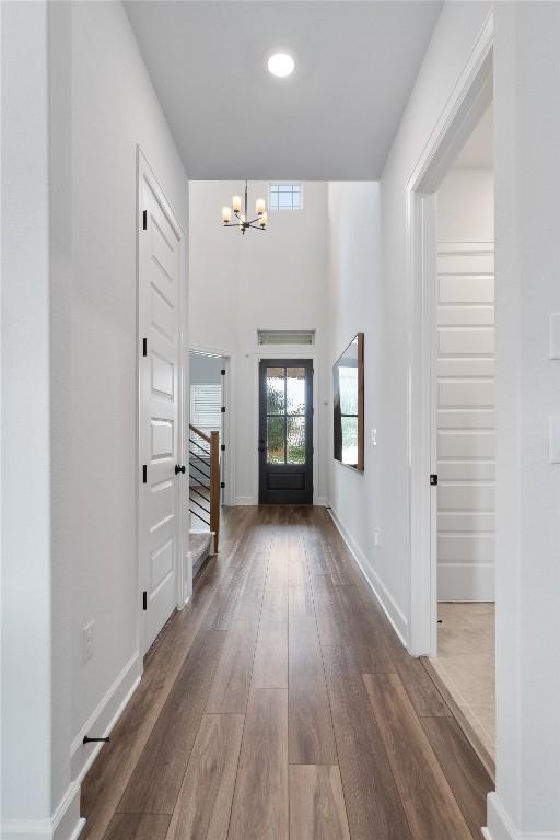 12915 Stanford Dr Unit 65, Austin, TX 78748 - foyer entrance with a chandelier, dark wood finished floors, baseboards, and stairway