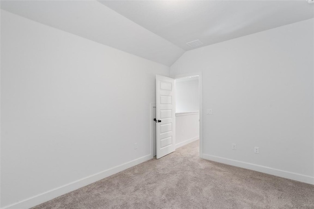 12915 Stanford Dr Unit 65, Austin, TX 78748 - empty room featuring light carpet, lofted ceiling, and baseboards