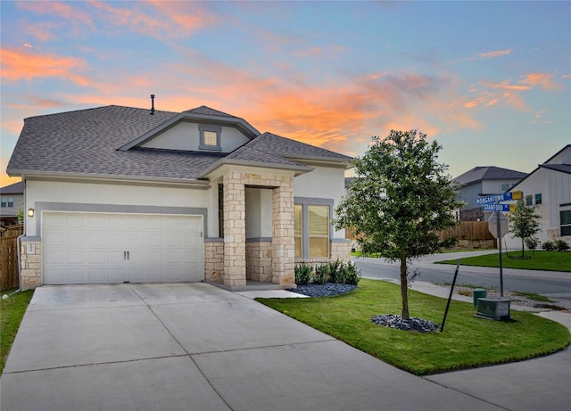 12915 Stanford Dr Unit 65, Austin, TX 78748 - view of front facade featuring stucco siding, stone siding, concrete driveway, an attached garage, and roof with shingles