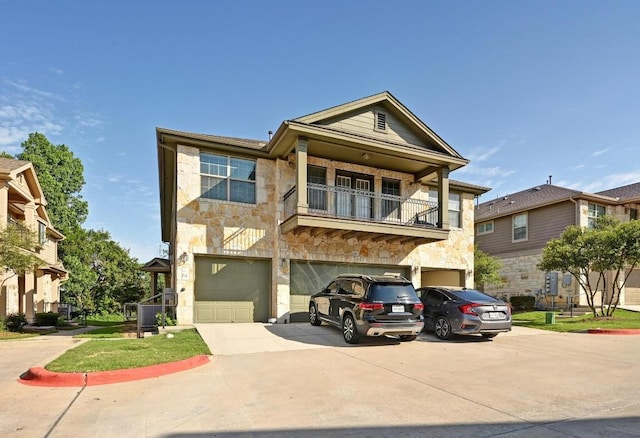 3101 Davis Ln Unit 6402, Austin, TX 78748 - townhome / multi-family property with stone siding, driveway, a balcony, and an attached garage