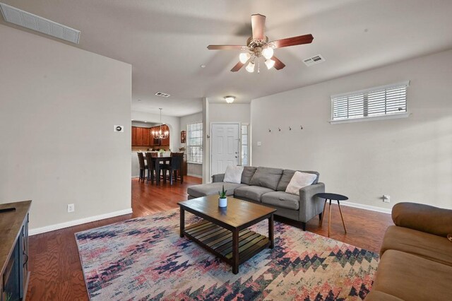 3101 Davis Ln Unit 6402, Austin, TX 78748 - living room featuring baseboards, a ceiling fan, dark wood finished floors, and a chandelier