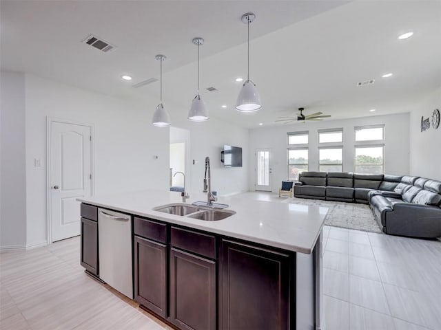 617 Silent Creek Cv, Georgetown, TX 78628 - kitchen featuring a sink, open floor plan, dishwasher, ceiling fan, and decorative light fixtures