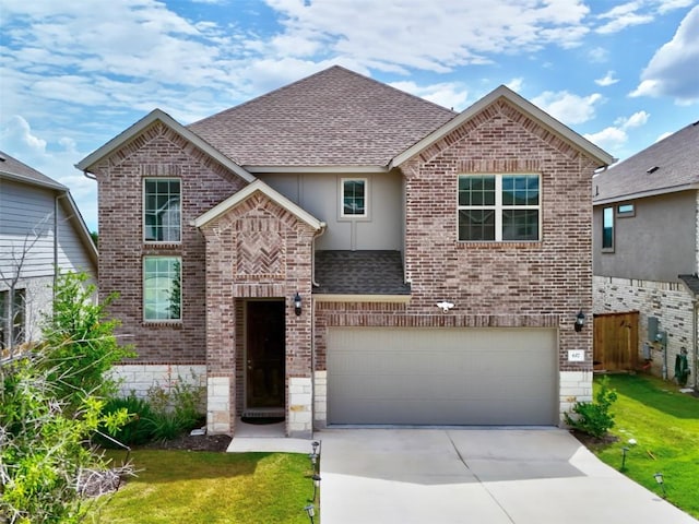 617 Silent Creek Cv, Georgetown, TX 78628 - view of front of property with roof with shingles, brick siding, an attached garage, concrete driveway, and a front lawn