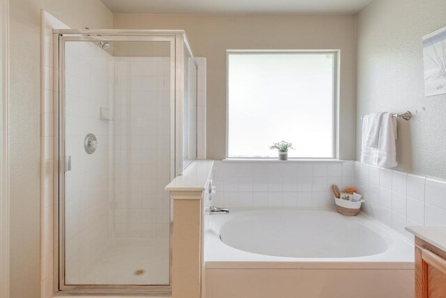 1303 Ridgewood Dr, Leander, TX 78641 - bathroom featuring a stall shower, a garden tub, and vanity