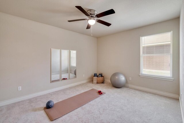 workout area featuring carpet, healthy amount of natural light, and a ceiling fan